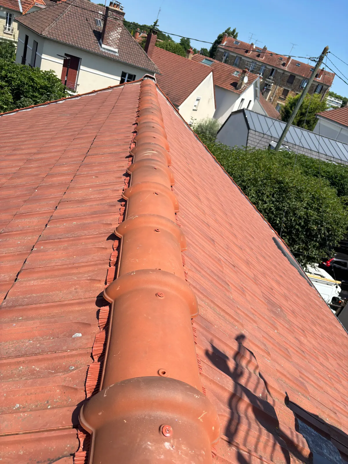 Faîtage d'une toiture en tuiles rouges rénovée en Seine-et-Marne